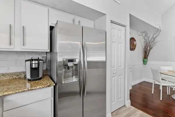 a kitchen with a refrigerator and a sink
