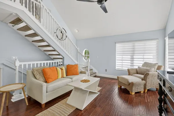 a living room with furniture and wooden floor
