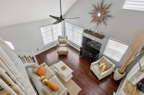 a living room with furniture and a wooden floor