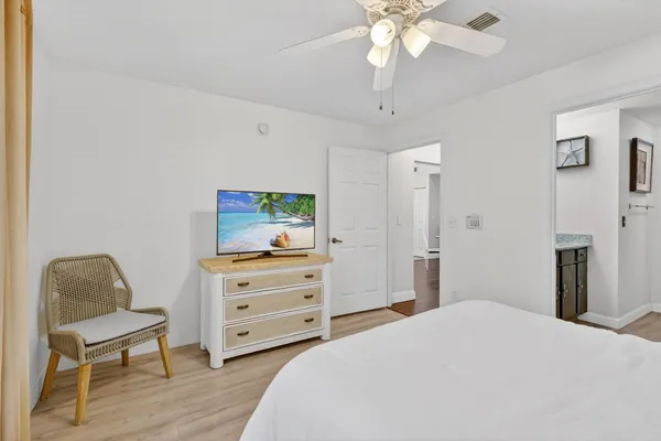 a bedroom with a bed and a chair