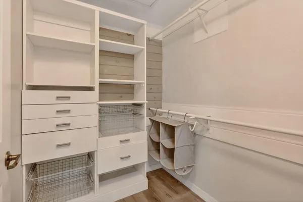 a view of walk in closet with empty racks