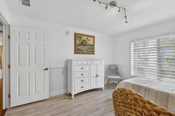 a bedroom with a baby bed and a window