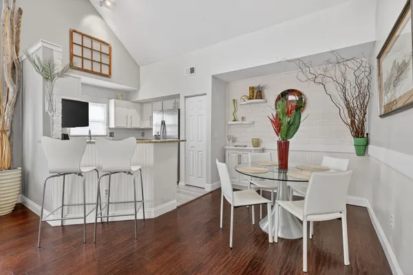 a view of a dining room with furniture and wooden floor