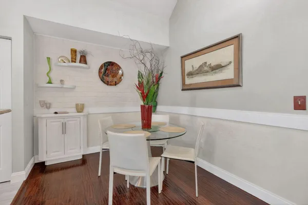 a view of a dining room with furniture and wooden floor