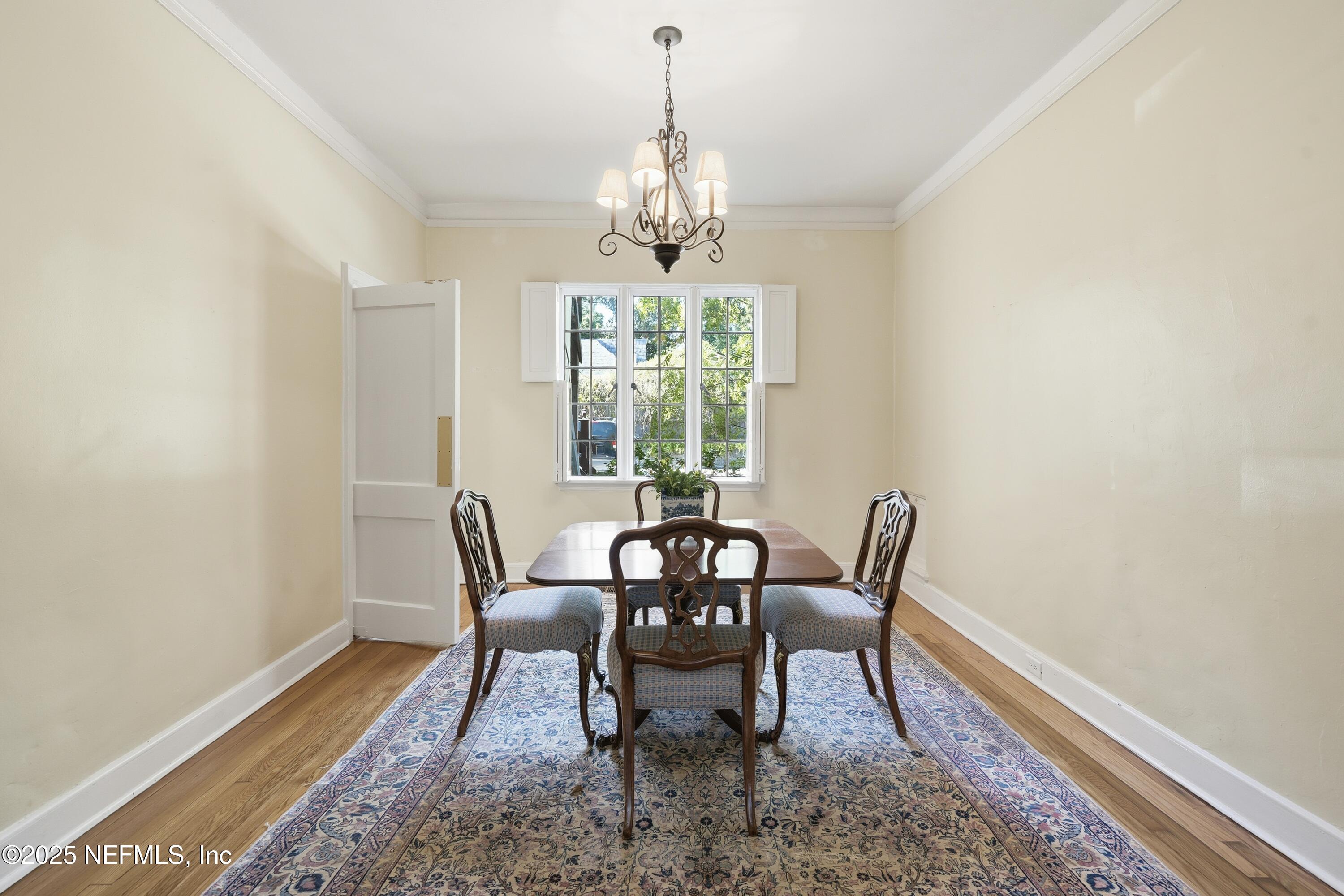 3319 Pine Street, Unit 2 Jacksonville, FL 32205 - Photo 11 of 31 a dining room with furniture a chandelier and wooden floor