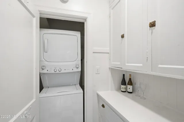 a kitchen with stainless steel appliances granite countertop a stove a sink and a white cabinets