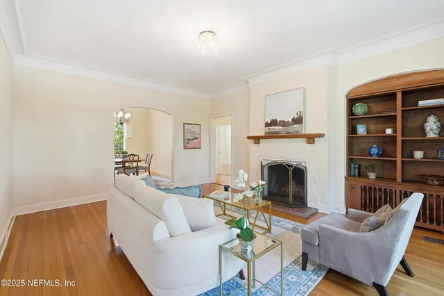 a living room with furniture a fireplace and a table