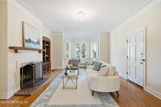 a living room with furniture a fireplace and a table