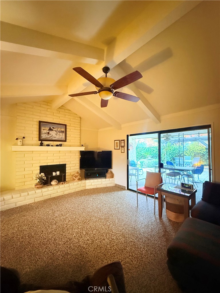 6380 North 5th Street Fresno, CA 93710 - Photo 24 of 31 a living room with furniture a fireplace and a floor to ceiling window