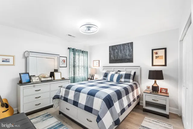 a bedroom with a bed and a dresser