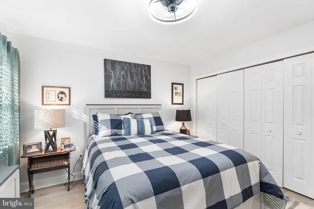 a bedroom with a bed and a painting on the wall