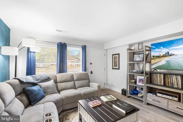 a living room with furniture and a book shelf