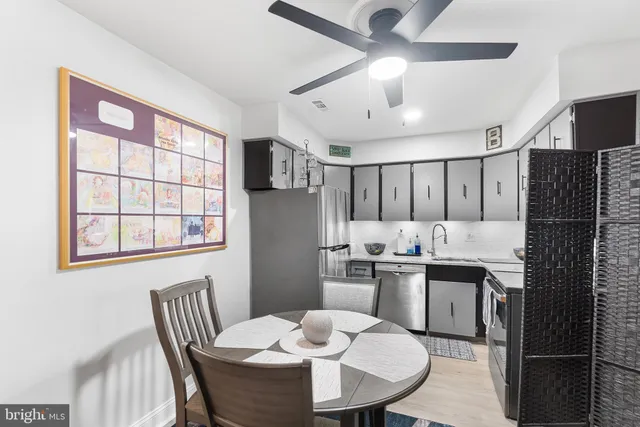 a kitchen with a table chairs stove and refrigerator