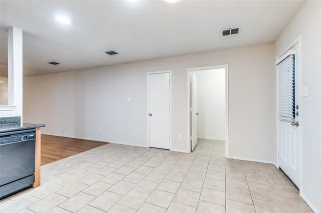 an empty room with white walls and windows