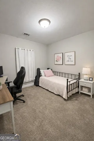 a spacious bedroom with a bed and a desk
