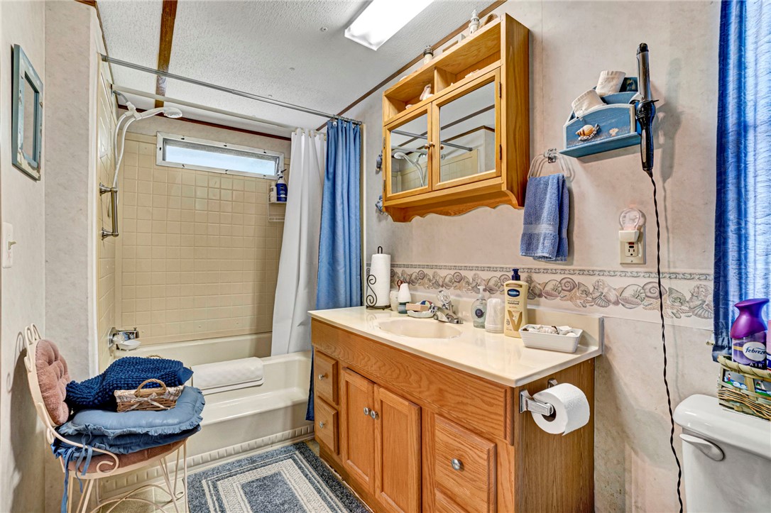 225 Nicholson Cove Road Seneca, SC 29672 - Photo 17 of 22 A well-appointed bathroom featuring a clean tub-shower combination and a vanity with a mirrored cabinet.