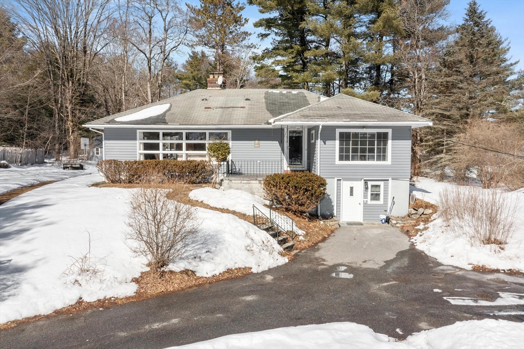 12 South Acton Road Stow, MA 01775 - Photo 2 of 41 a front view of a house with a yard covered in snow