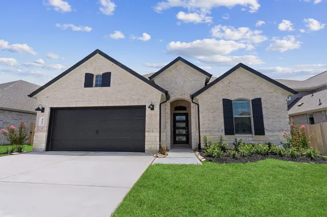 a view of a house with a yard and garage