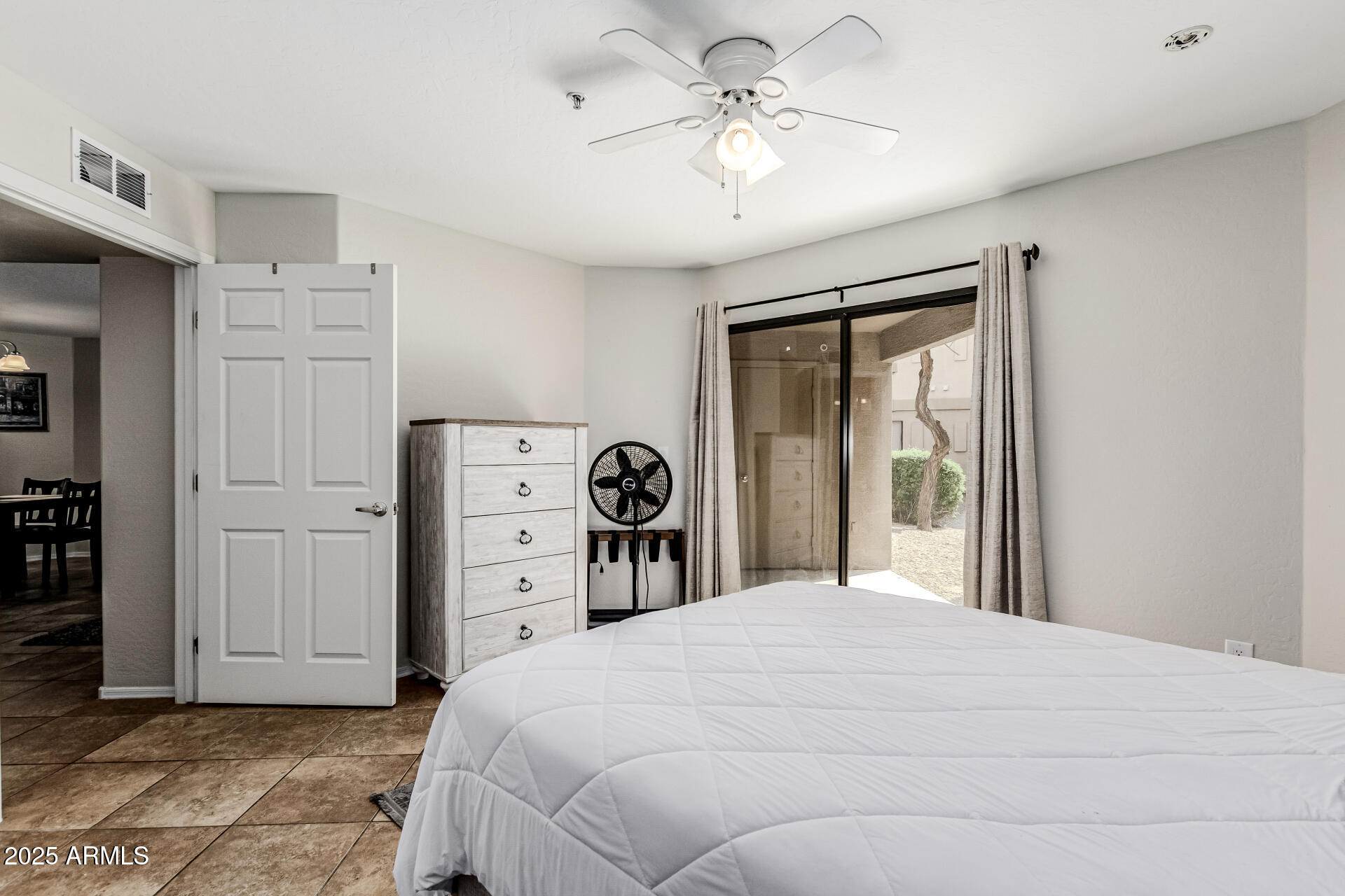 1287 North Alma School Road, Unit 156 Chandler, AZ 85224 - Photo 11 of 34 a bedroom with a large bed and a chandelier