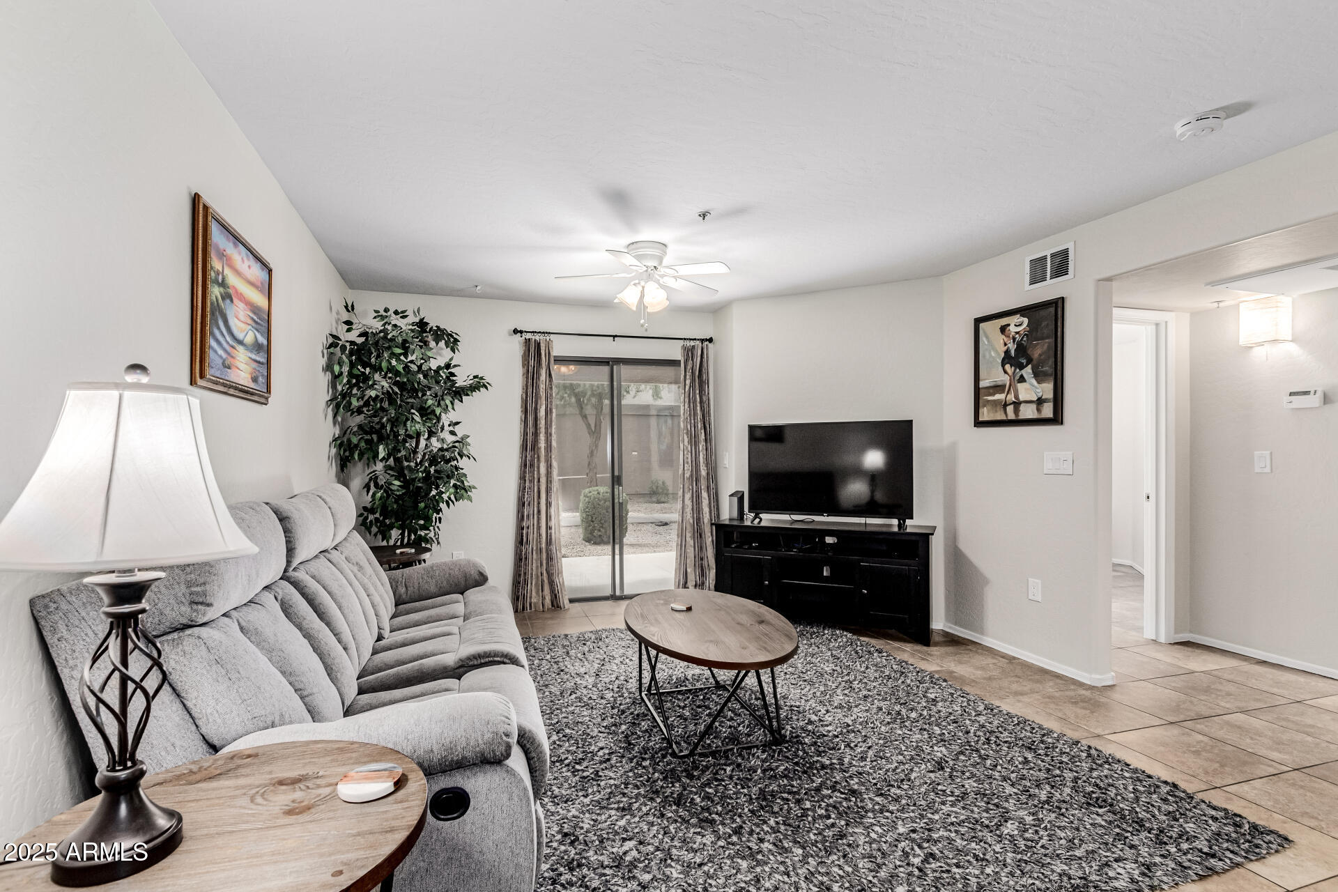 1287 North Alma School Road, Unit 156 Chandler, AZ 85224 - Photo 2 of 34 a living room with furniture and a flat screen tv