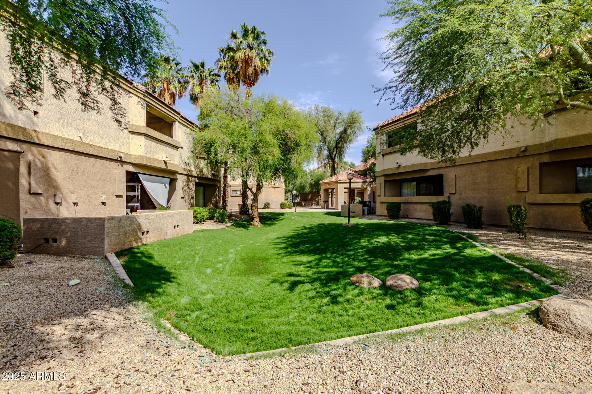 1287 North Alma School Road, Unit 156 Chandler, AZ 85224 - Photo 23 of 34 a front view of a house with a garden and plants