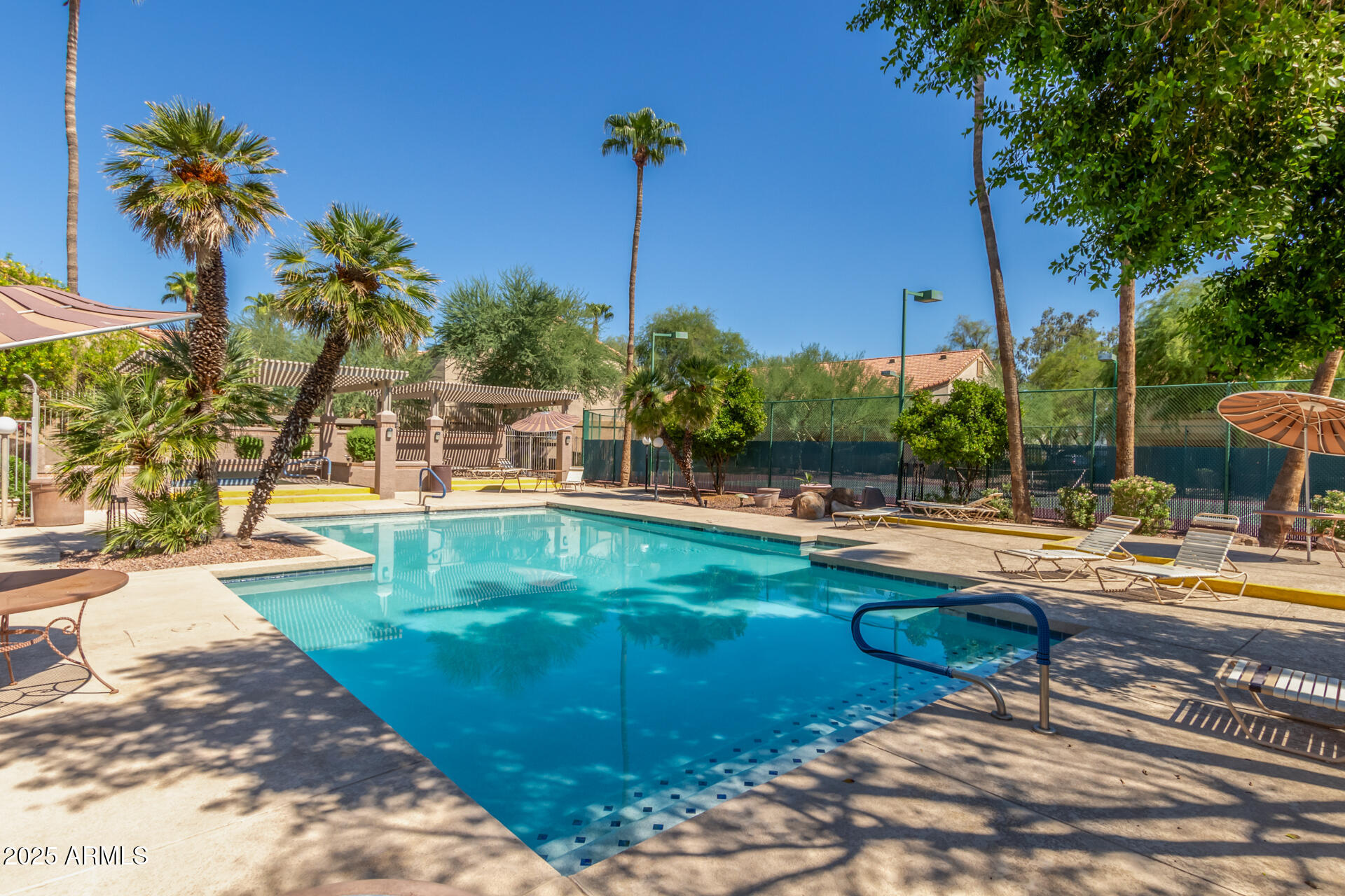 1287 North Alma School Road, Unit 156 Chandler, AZ 85224 - Photo 25 of 34 a swimming pool with outdoor seating and yard