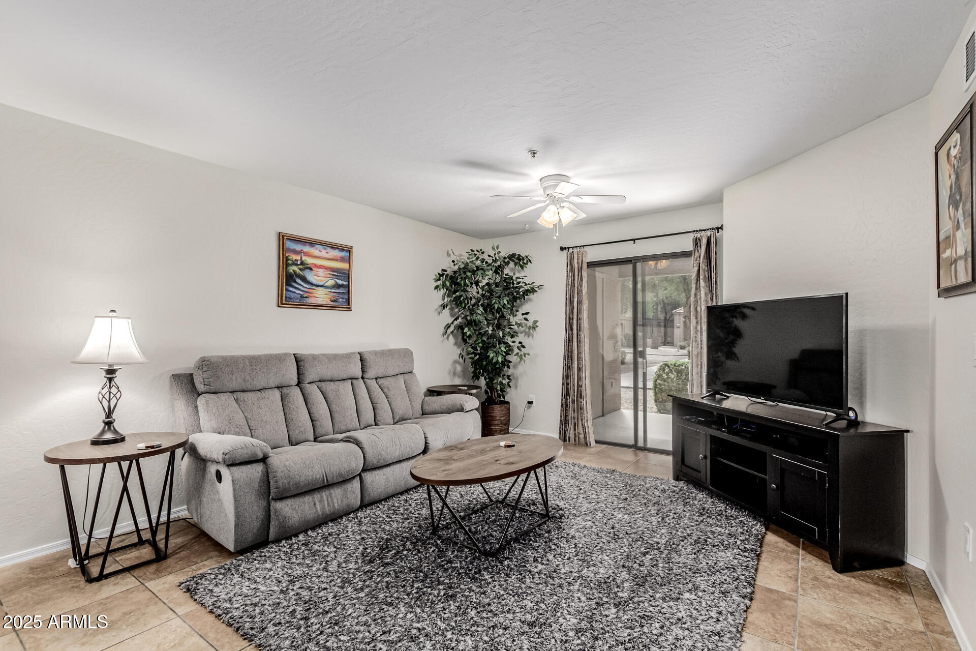 1287 North Alma School Road, Unit 156 Chandler, AZ 85224 - Photo 3 of 34 a living room with furniture and a flat screen tv