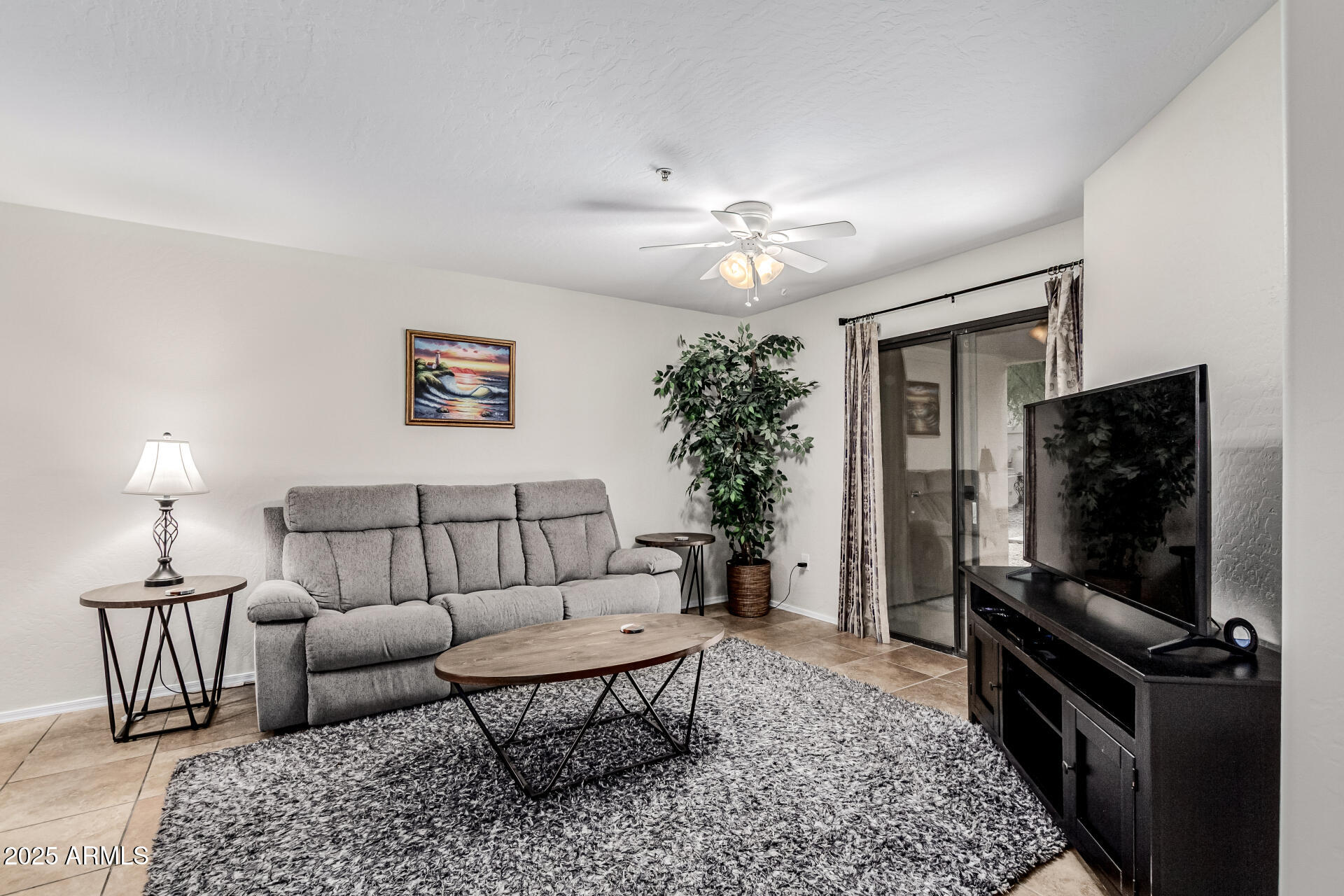 1287 North Alma School Road, Unit 156 Chandler, AZ 85224 - Photo 5 of 34 a living room with furniture and a flat screen tv