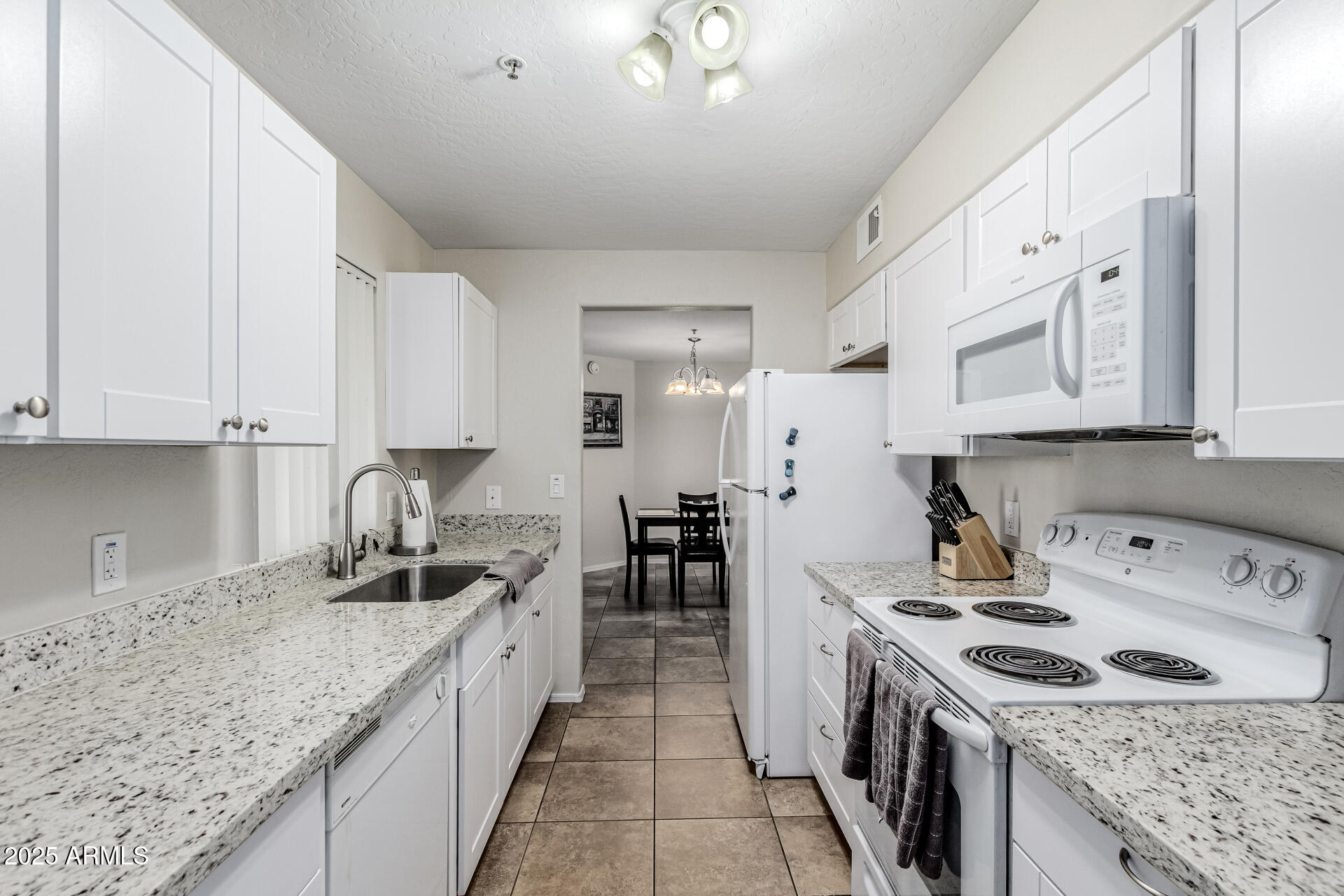 1287 North Alma School Road, Unit 156 Chandler, AZ 85224 - Photo 7 of 34 a kitchen with a sink stove top oven and cabinets