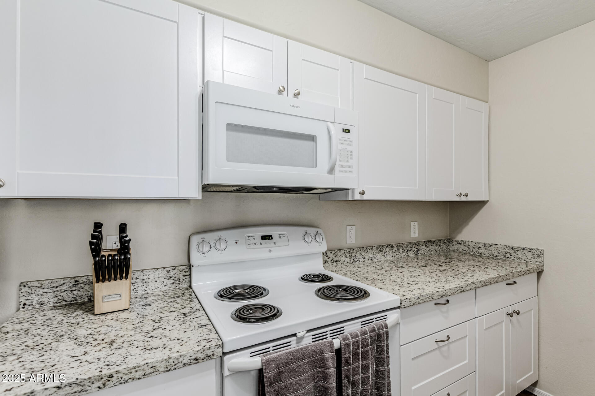 1287 North Alma School Road, Unit 156 Chandler, AZ 85224 - Photo 9 of 34 a kitchen with a stove and a microwave