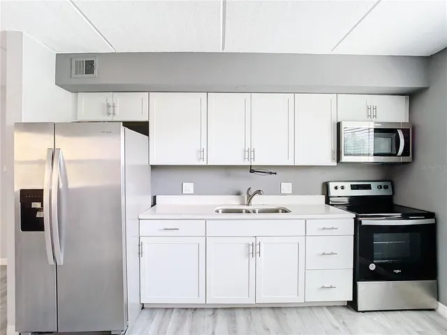 a kitchen with a sink a stove and refrigerator