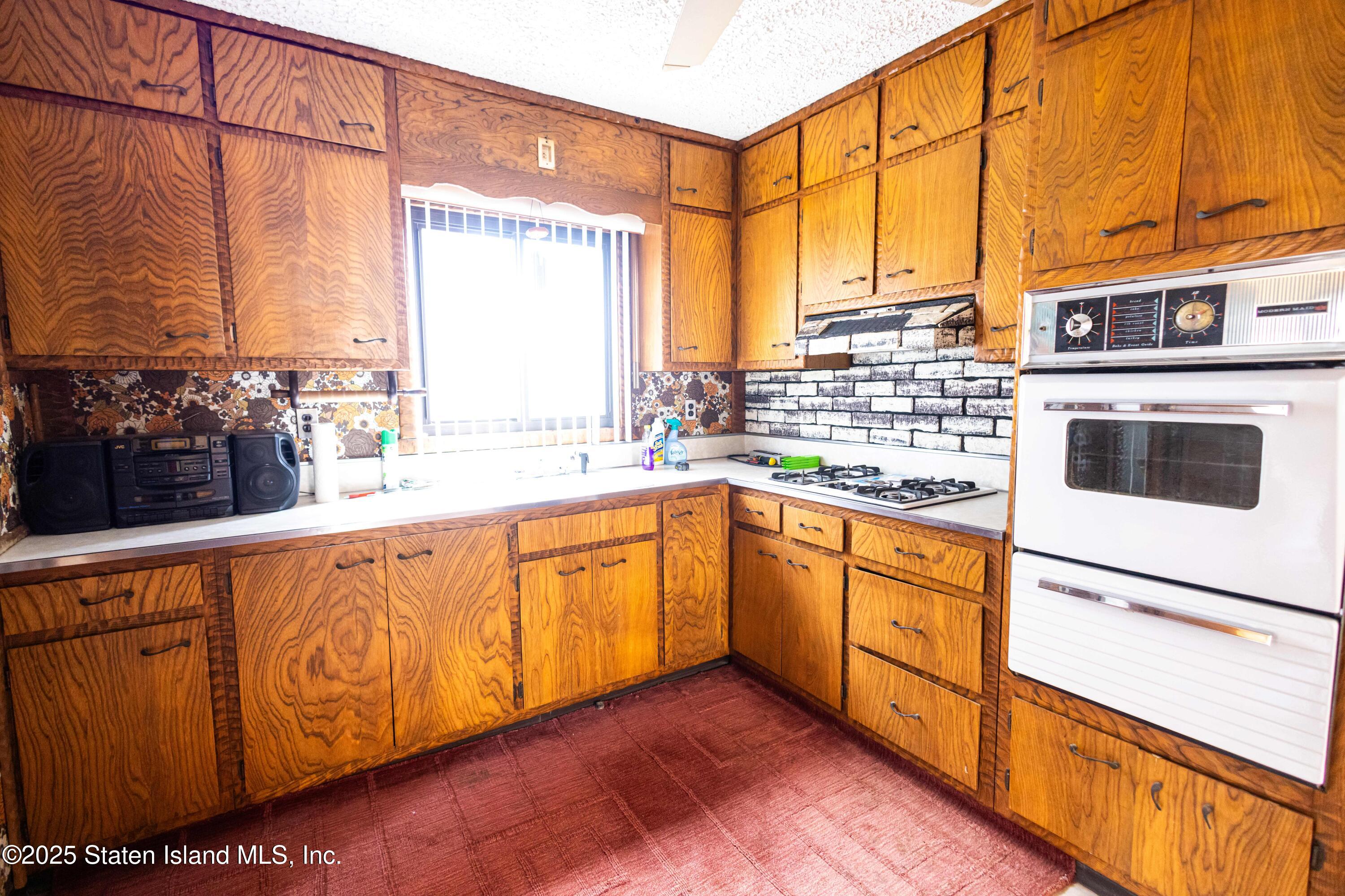 186 Raritan Avenue Staten Island, NY 10304 - Photo 12 of 51 a kitchen with stainless steel appliances granite countertop a stove a sink and a microwave