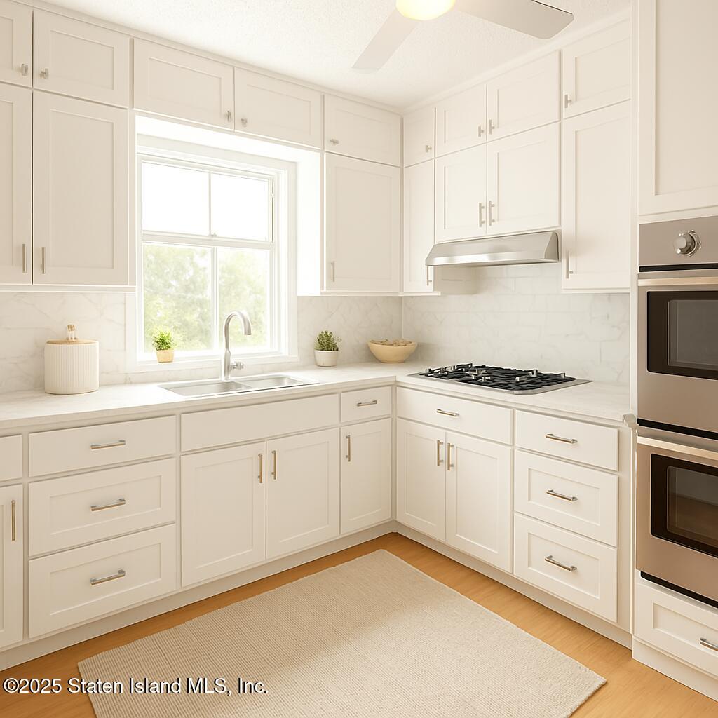 186 Raritan Avenue Staten Island, NY 10304 - Photo 13 of 51 a kitchen with cabinets appliances a sink and a window