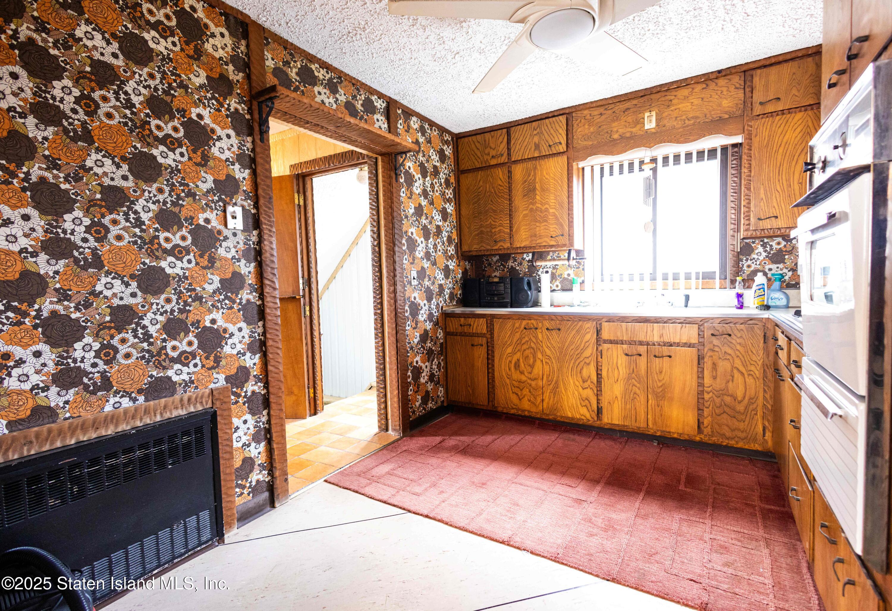186 Raritan Avenue Staten Island, NY 10304 - Photo 14 of 51 a view of a kitchen with a sink and a fireplace
