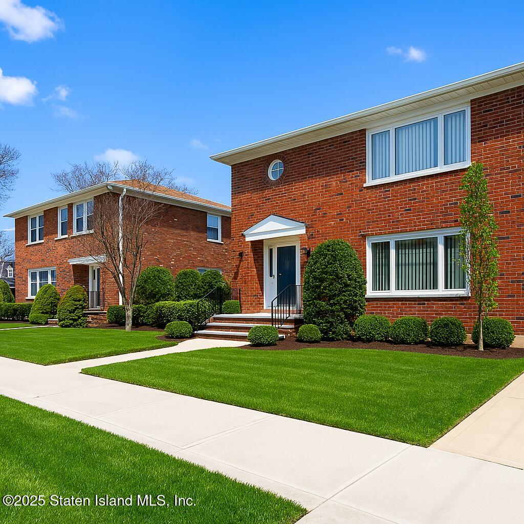 186 Raritan Avenue Staten Island, NY 10304 - Photo 2 of 51 a front view of a house with a yard and garage