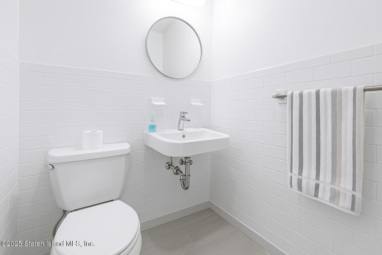 186 Raritan Avenue Staten Island, NY 10304 - Photo 32 of 51 a bathroom with a sink a toilet and a mirror