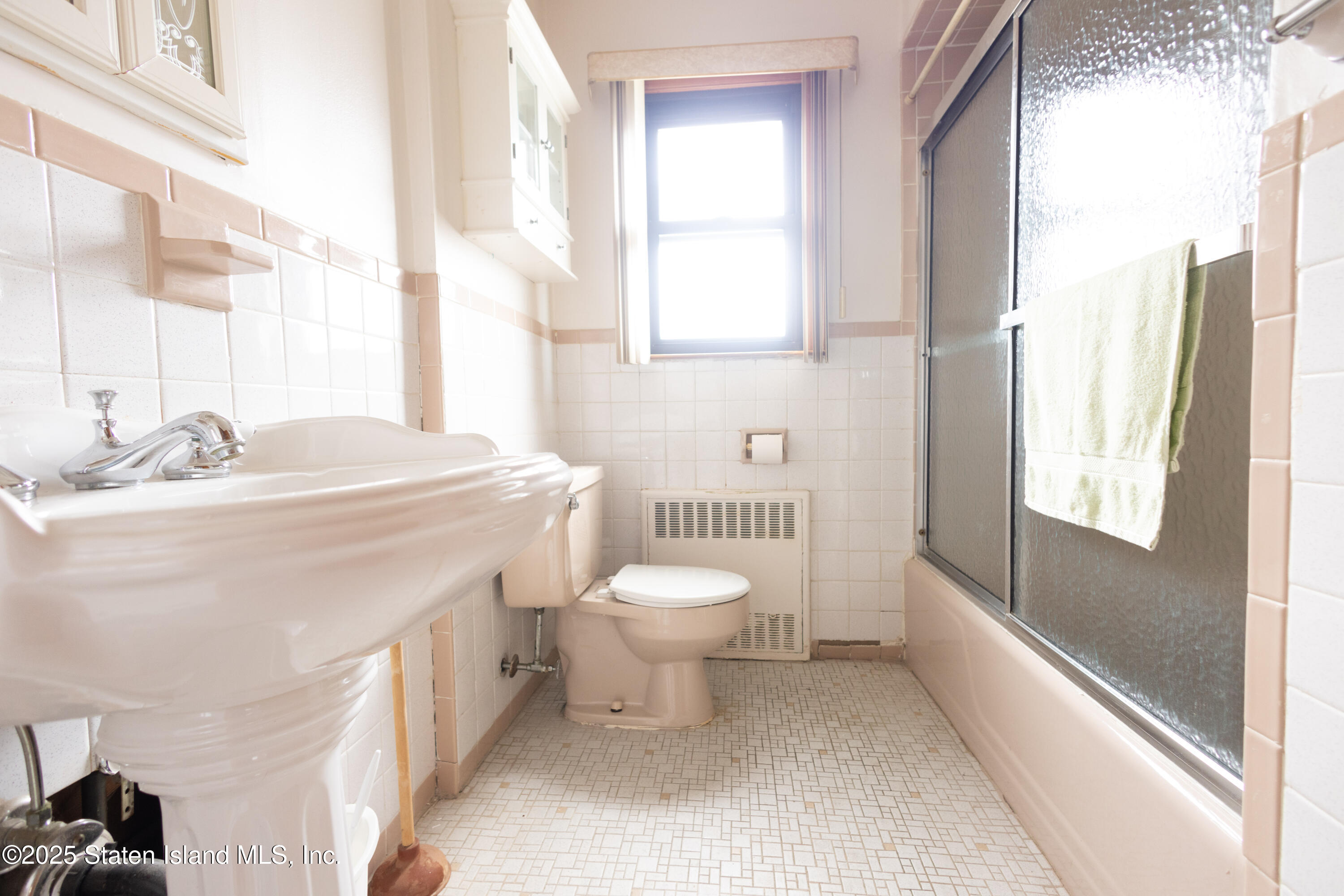 186 Raritan Avenue Staten Island, NY 10304 - Photo 45 of 51 a bathroom with a sink a toilet and a window