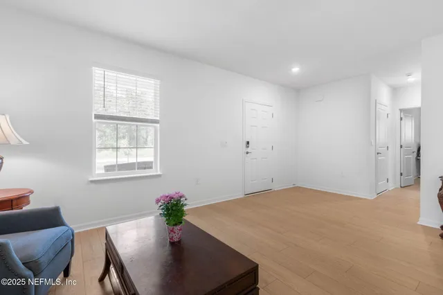 an empty room with windows and television