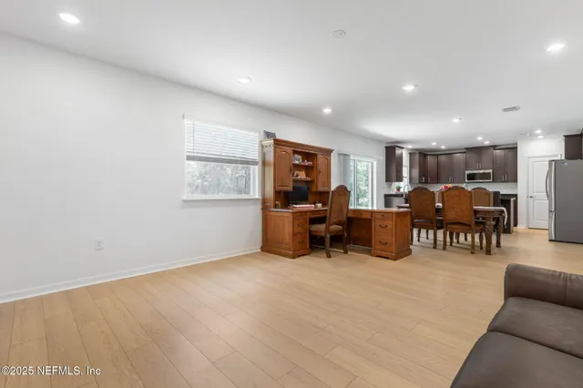 a work room with table and a potted plant