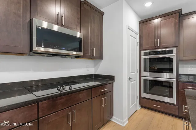 a view of a green field with lots of bushes