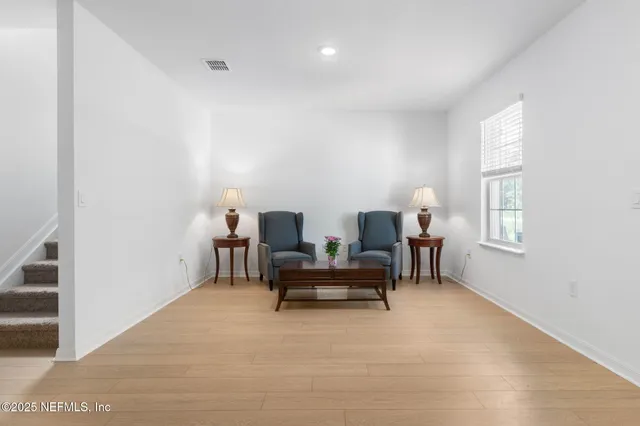 a bathroom with a granite countertop sink a toilet and a mirror