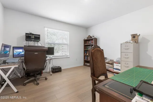 a living room with furniture and a dining table