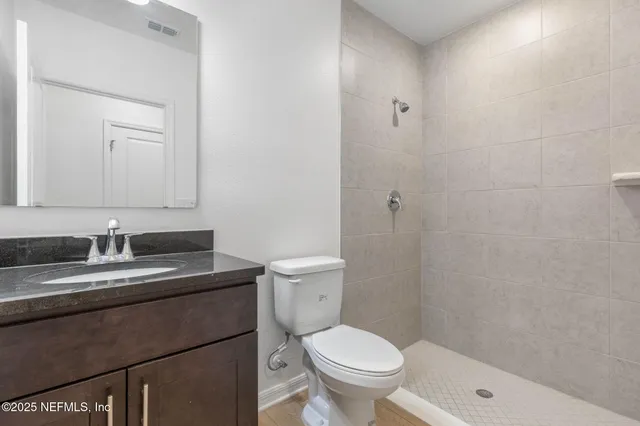 a kitchen with granite countertop a stove and a microwave