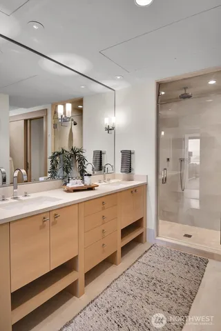 a spacious bathroom with a shower sink and mirror