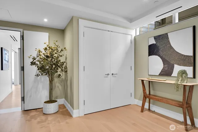 a living room with furniture and floor to ceiling window