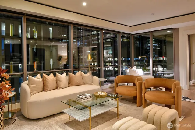 a living room with furniture and large windows