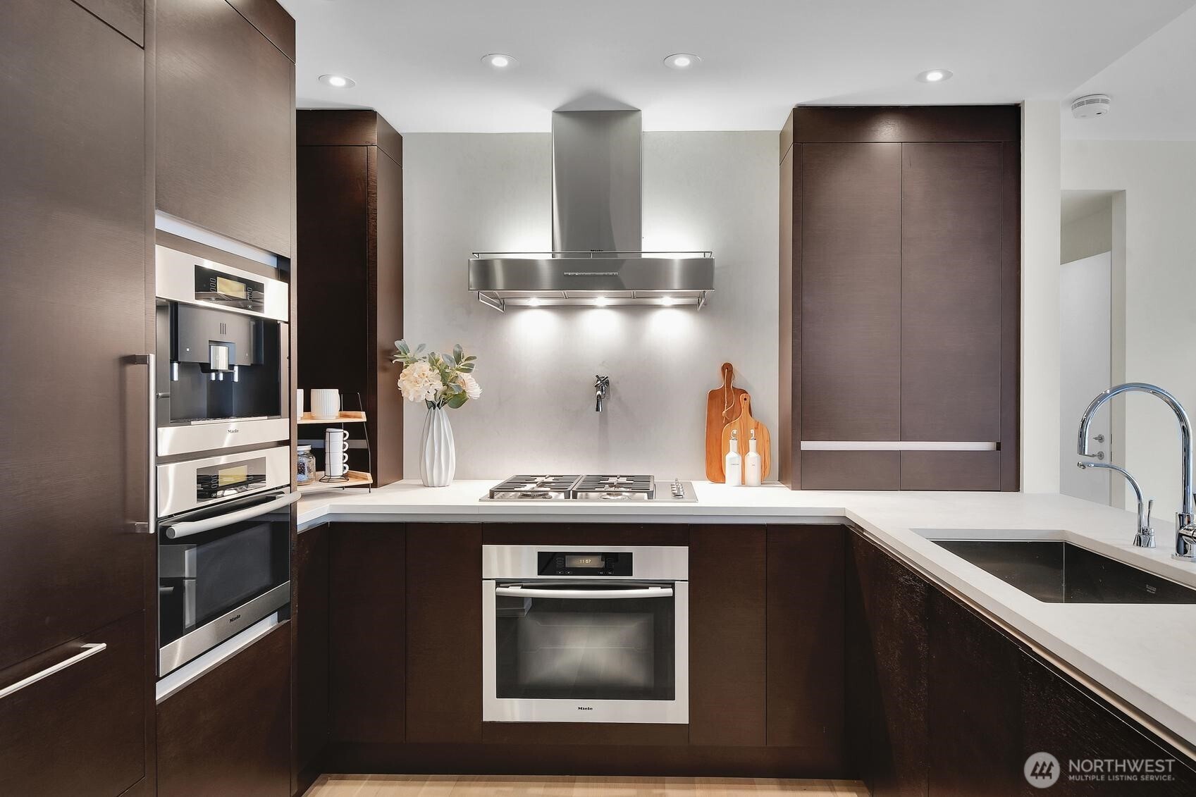 99 Union Street, Unit 1205 & 1206 Seattle, WA 98101 - Photo 22 of 40 a kitchen with stainless steel appliances granite countertop a sink and a refrigerator