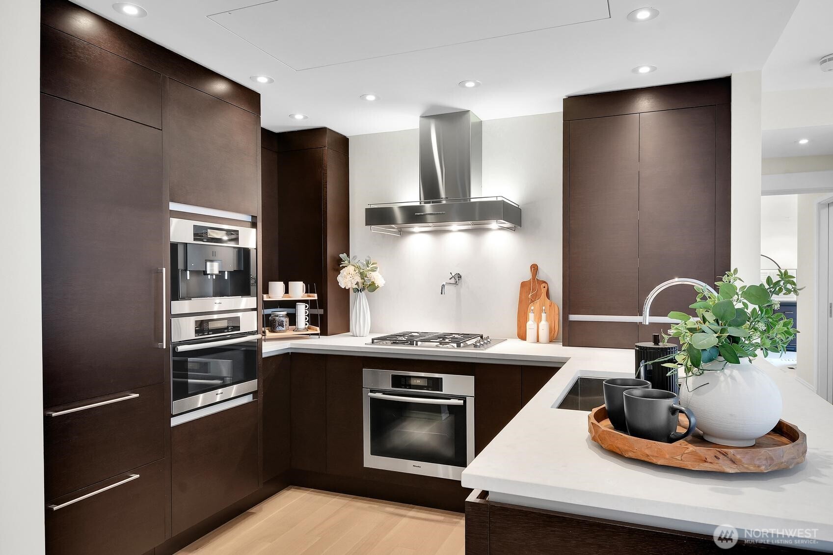 99 Union Street, Unit 1205 & 1206 Seattle, WA 98101 - Photo 23 of 40 a kitchen with a sink and stainless steel appliances