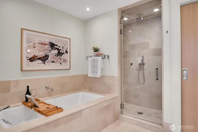 a spacious bathroom with a double vanity sink a large mirror and shower