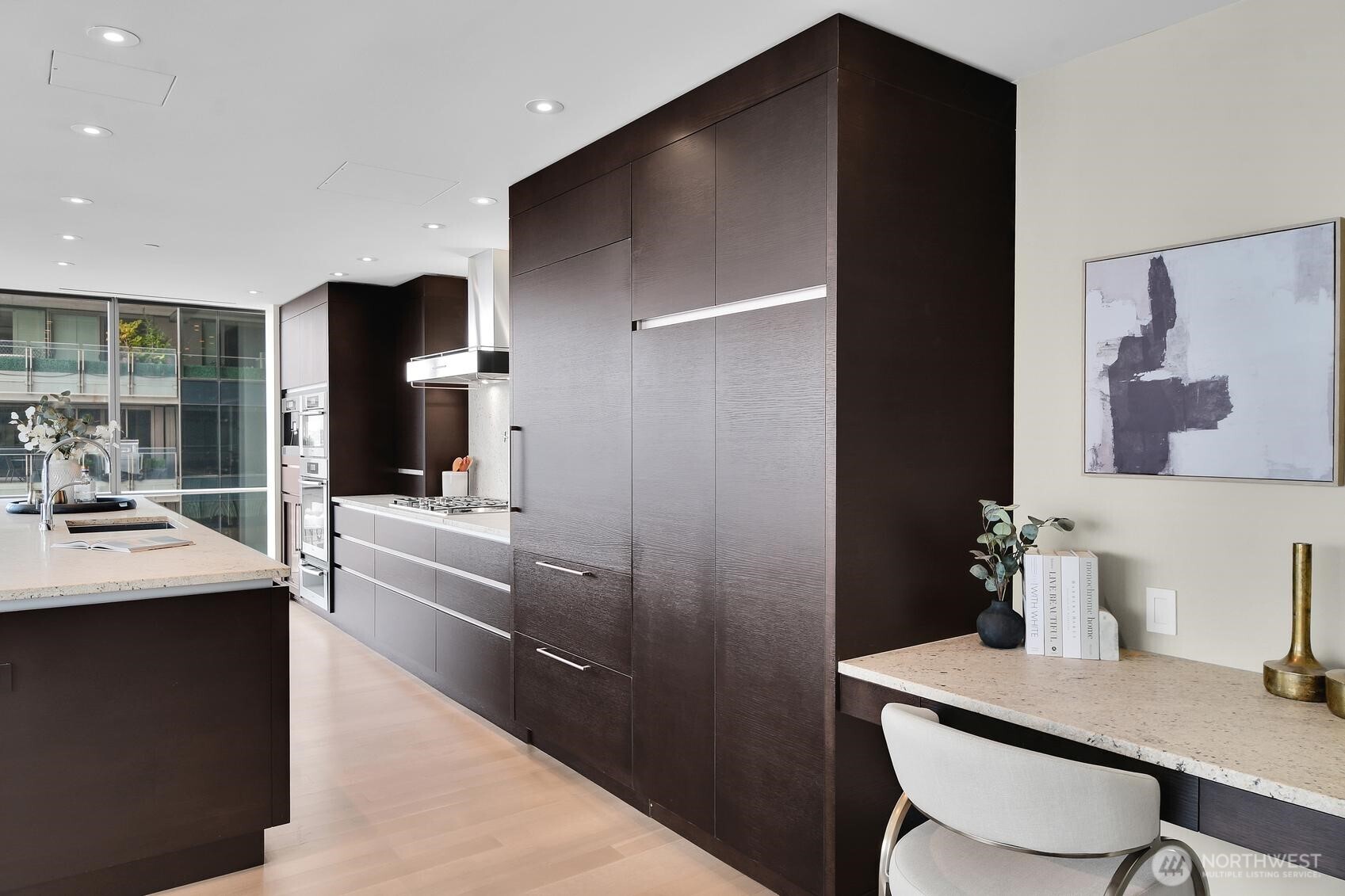 99 Union Street, Unit 1205 & 1206 Seattle, WA 98101 - Photo 3 of 40 a kitchen with a table and chairs